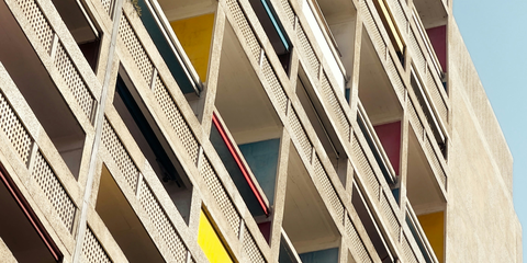 Low-resolution photograph of colored balconies and concrete railings in Marseille.